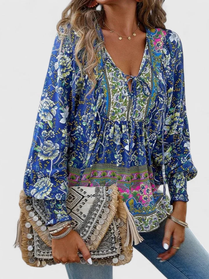 Stylish women's floral blouse with a V-neck tie, smocked puff sleeves, ideal for spring fashion.