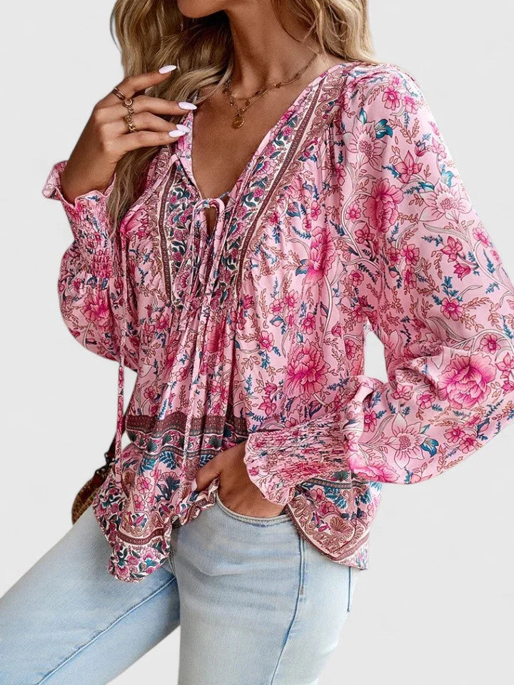 Elegant women's boho V-neck blouse with a beautiful floral print and fashionable puff sleeves.