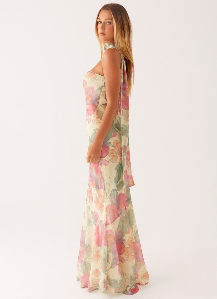 Vibrant floral print maxi dress with cold shoulder & halter neck. A stylish, flowing summer dress for women.