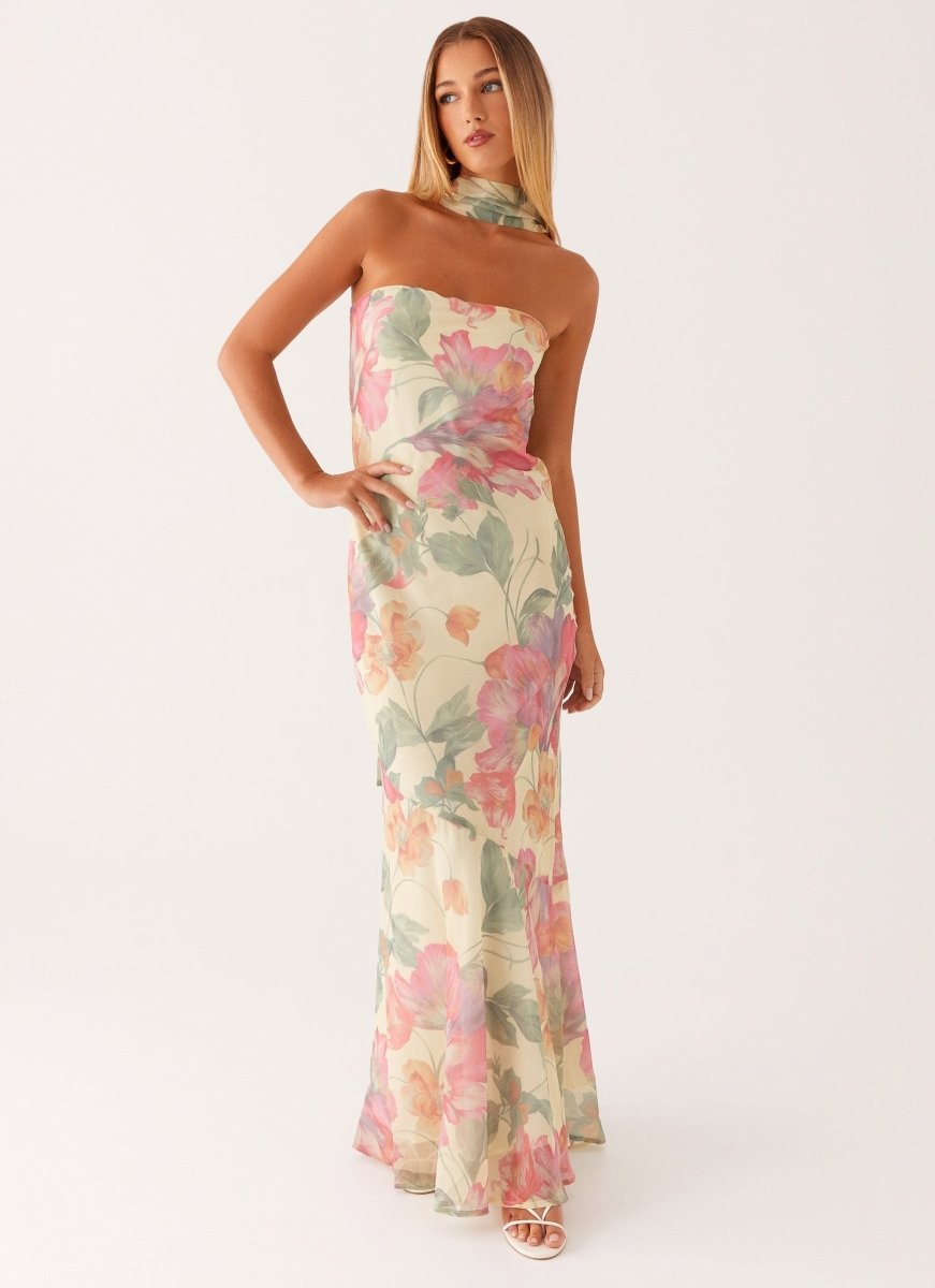 Elegant women's floral cold-shoulder halter neck maxi dress, showcasing its flowing silhouette and V-neck.