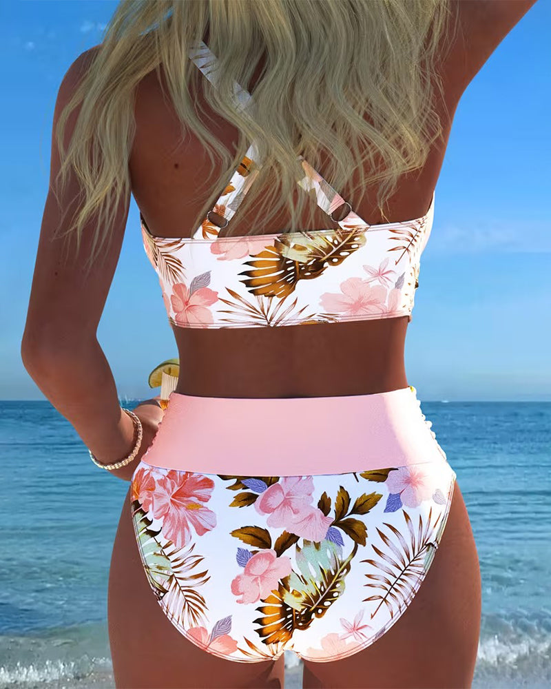 Feminine floral print high-waisted swimsuit with chic cut-outs. A stylish bikini set for women's summer fashion.