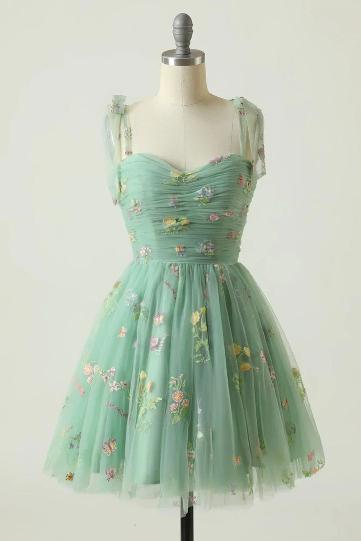 Floral embroidered cocktail dress for women, sleeveless, with a distinctive layered skirt design, perfect for special events.