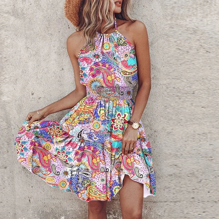 Vibrant floral print women's flowy halter mini dress with flattering smocked waist. Ideal for spring/summer fashion.