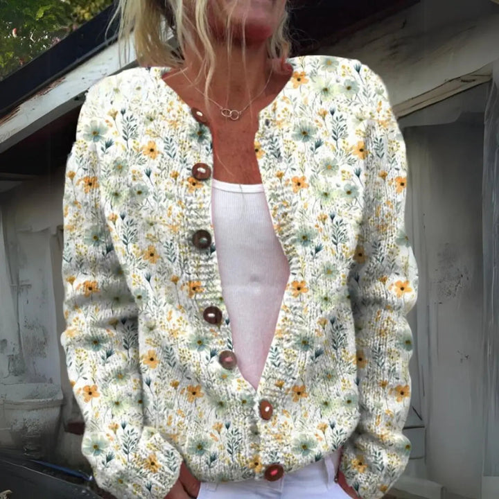 Women's floral knit button-up cardigan vest. Elegant autumn layering piece with a vibrant floral print.