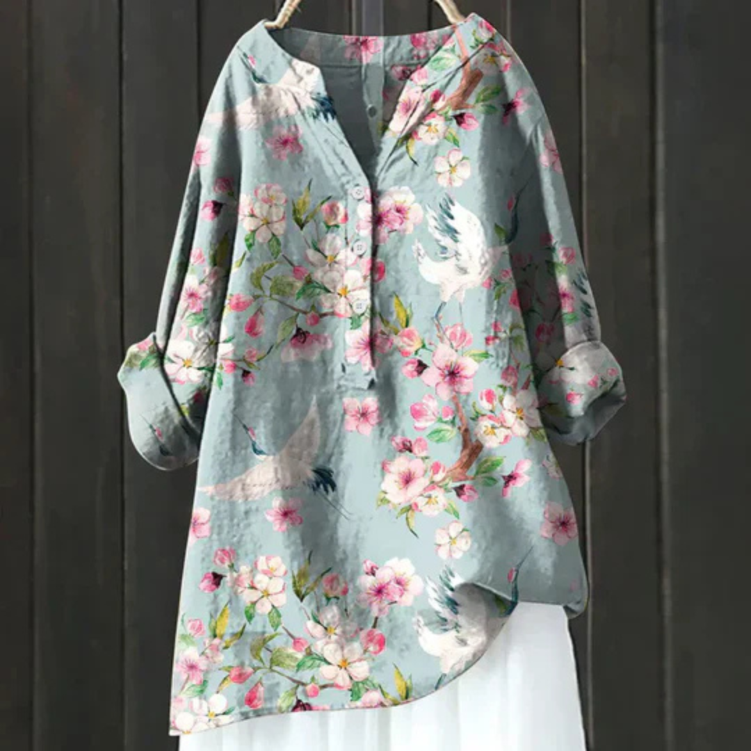 Women's floral long sleeve blouse with vibrant print, V-neck, and button-up front. Loose, stylish fit.