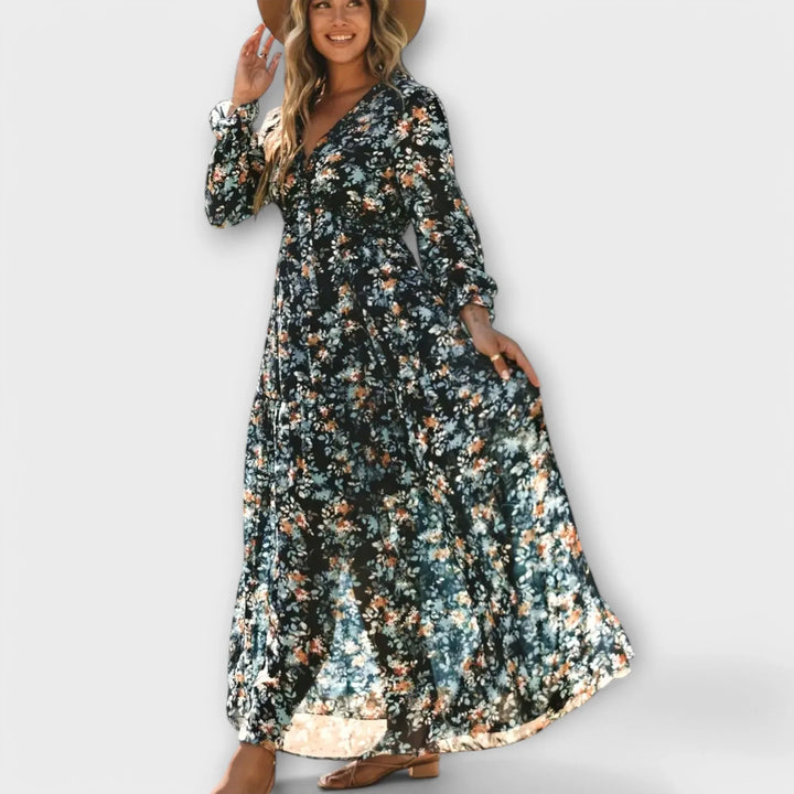 Close-up of ruffled V-neck on a women's floral maxi dress with tiered skirt. Spring fashion statement.