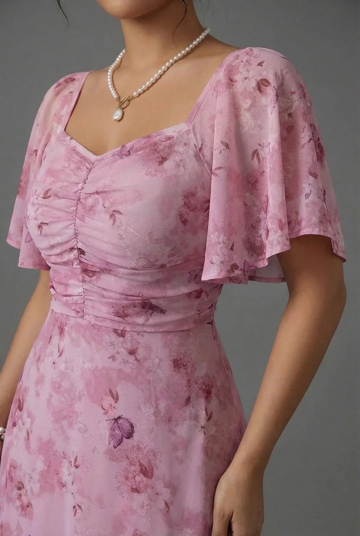 Elegant women's floral maxi dress with flutter sleeves, a chic choice for wedding guests and special occasions.