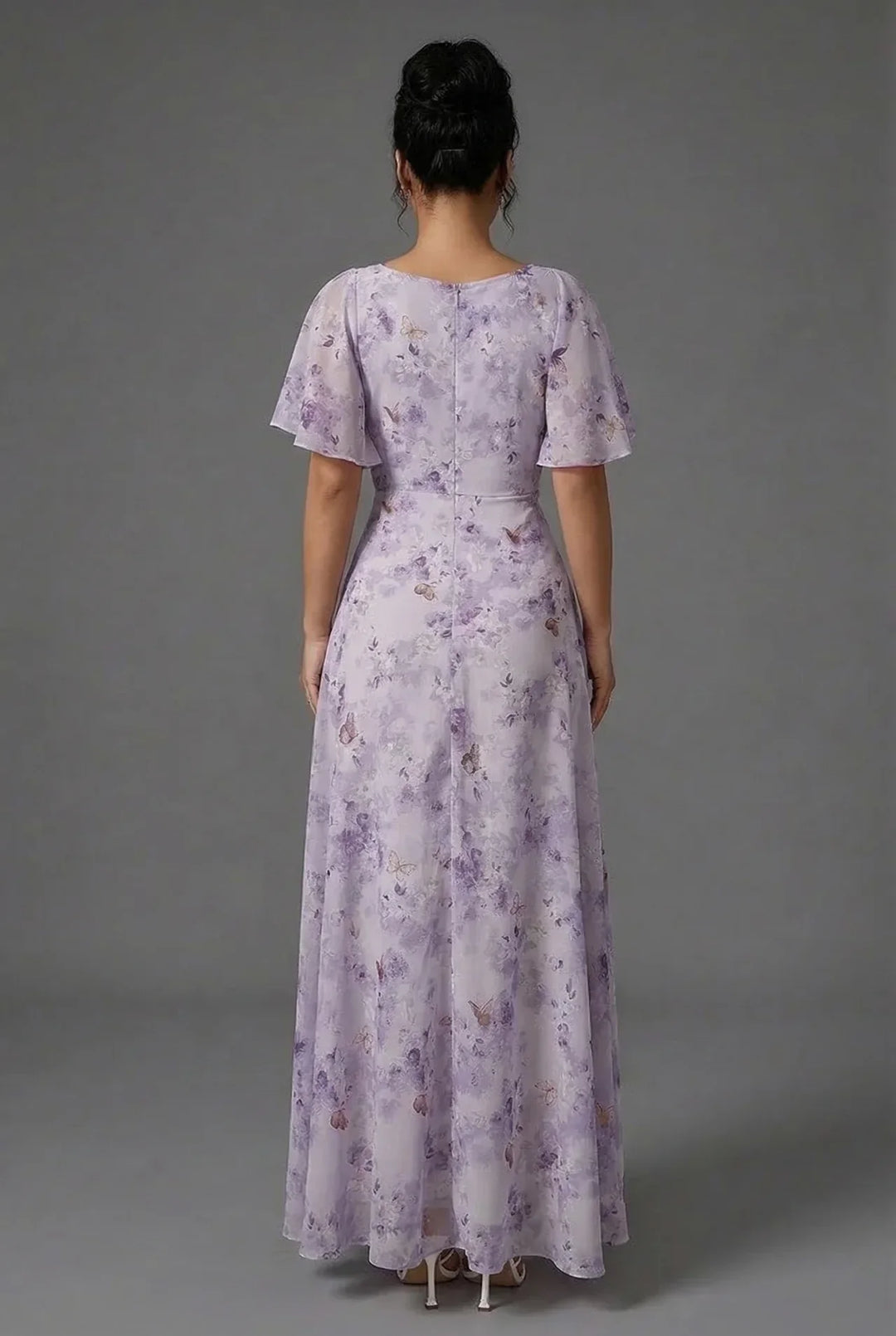 Flowy floral maxi dress for women, perfect as a wedding guest or special occasion outfit with pretty flutter sleeves.