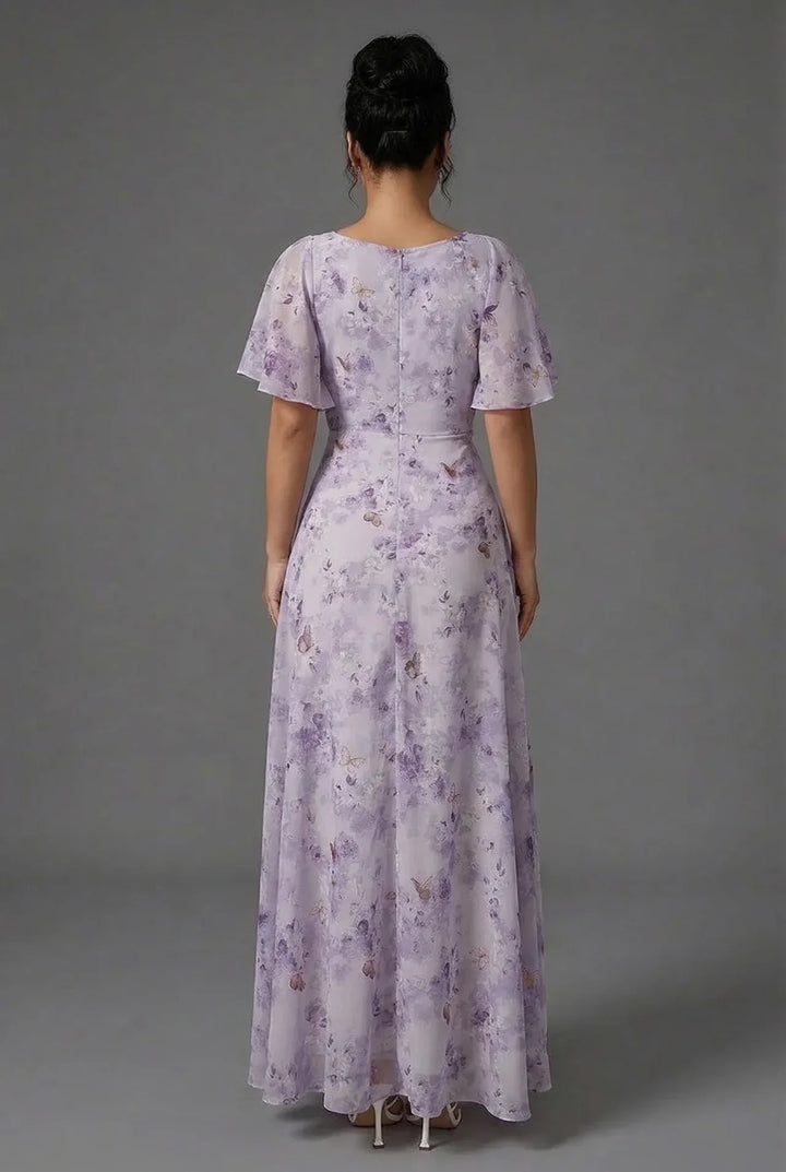 Flowy floral maxi dress for women, perfect as a wedding guest or special occasion outfit with pretty flutter sleeves.