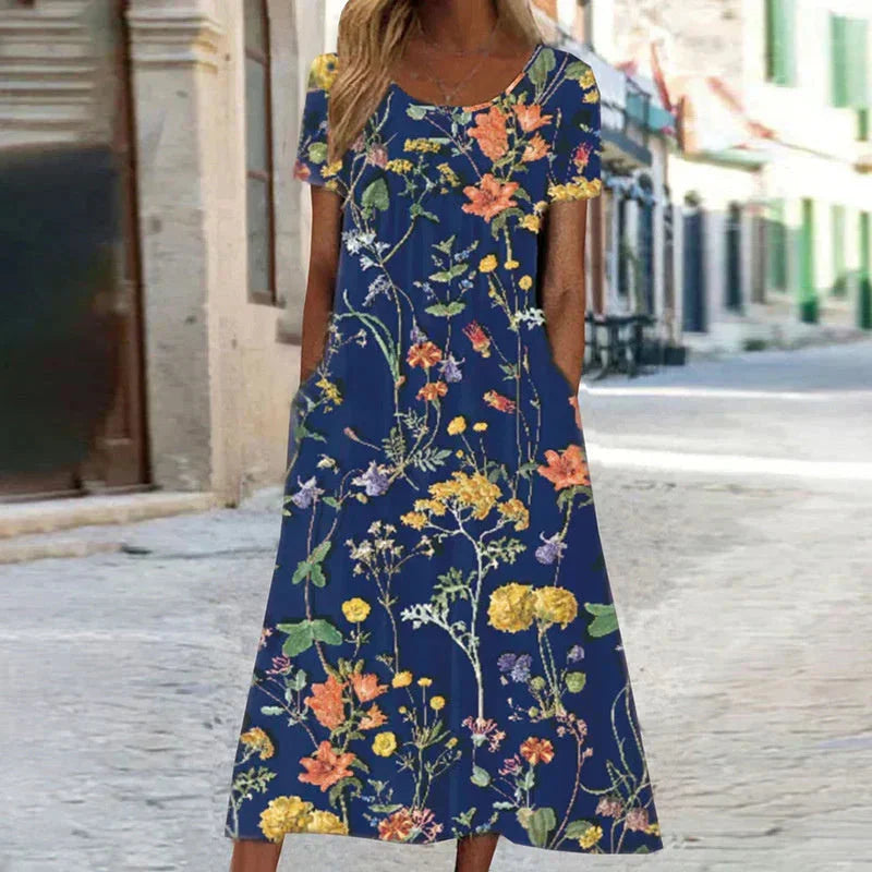 Women's floral midi dress with short sleeves, scoop neck, and practical pockets, perfect for summer casual wear.