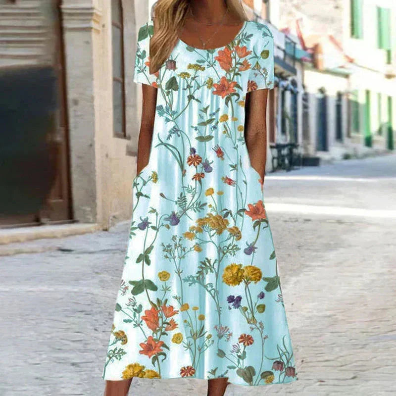 Vibrant floral midi dress for women, featuring short sleeves, scoop neck, and hidden pockets for comfort & style.