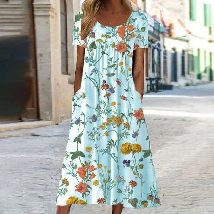Vibrant floral midi dress for women, featuring short sleeves, scoop neck, and hidden pockets for comfort & style.