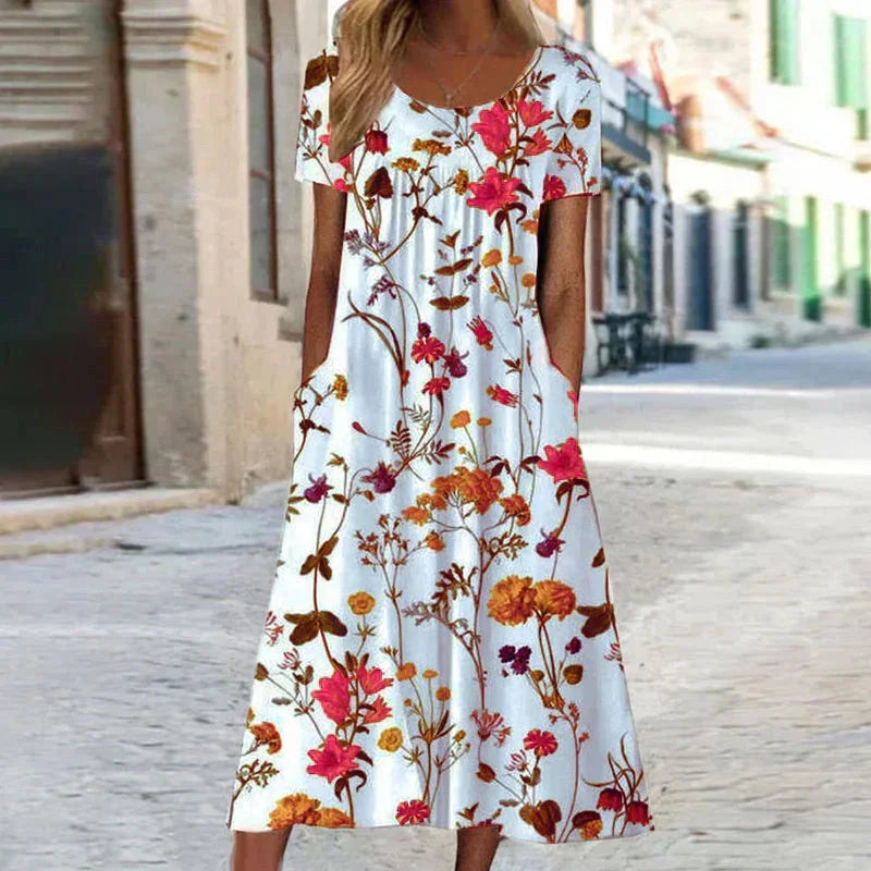 Beautiful women's floral print midi dress, with short sleeves, scoop neckline, and convenient side pockets.