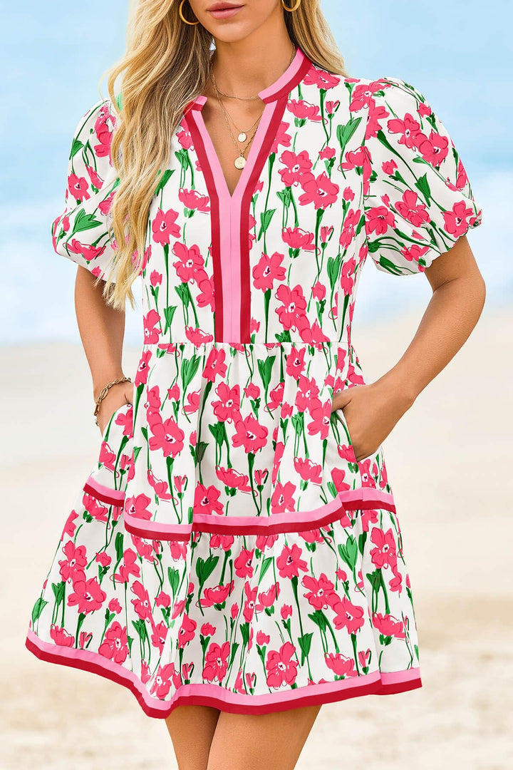 Full view of a woman wearing a stylish floral mini dress, puff sleeves, V-neck. Perfect casual summer outfit.