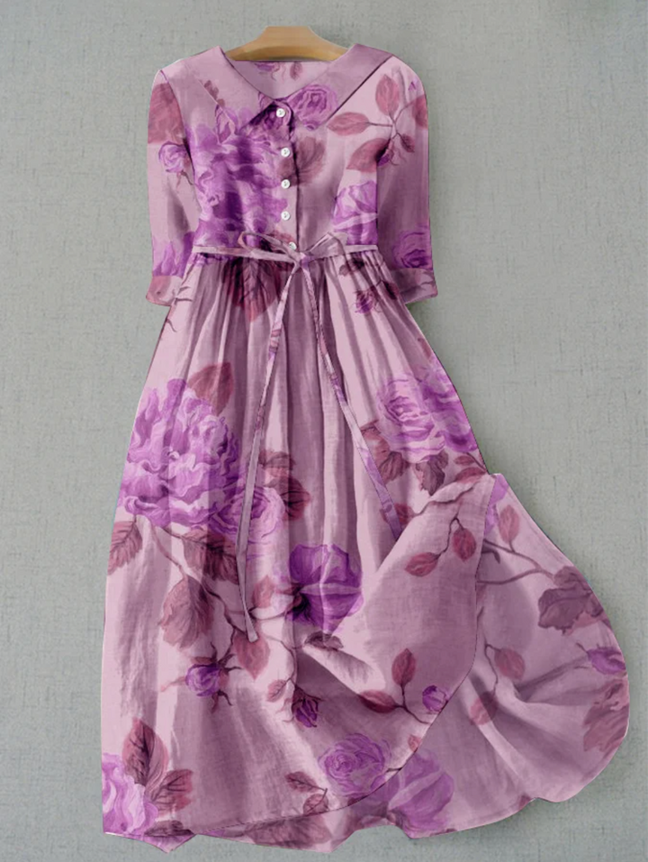 Close-up of a women's floral patterned button-down midi dress, highlighting the vibrant print & fabric.