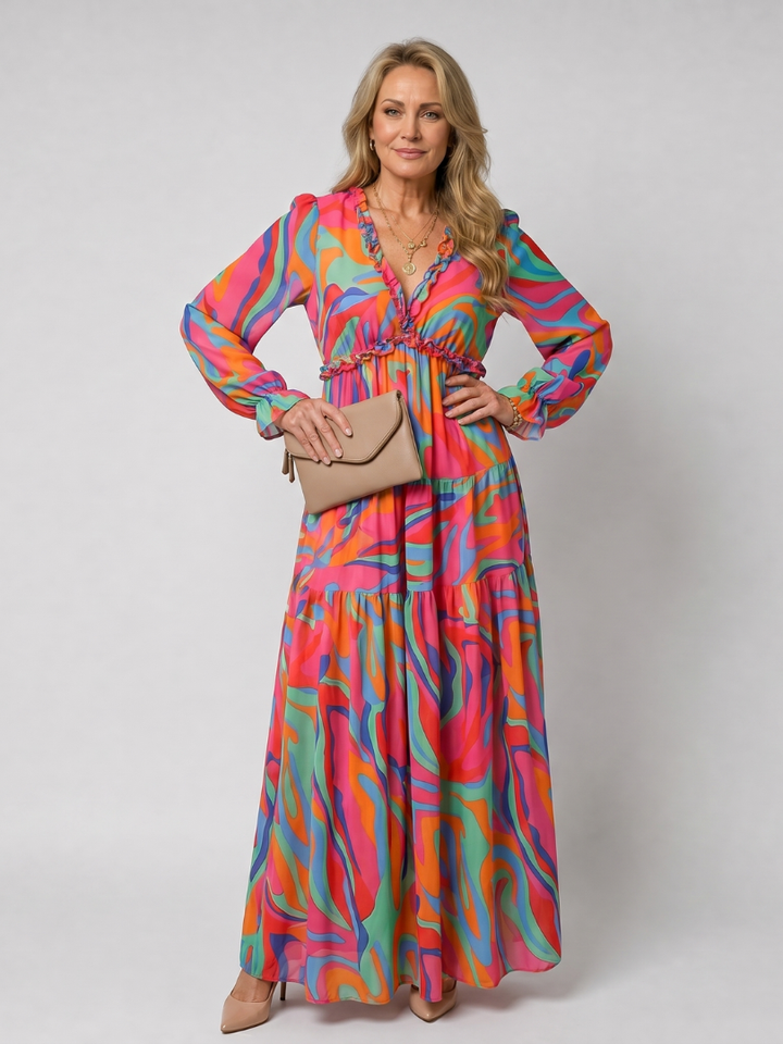 Flowing women's floral print long sleeve tiered maxi dress, perfect for a breezy summer day.