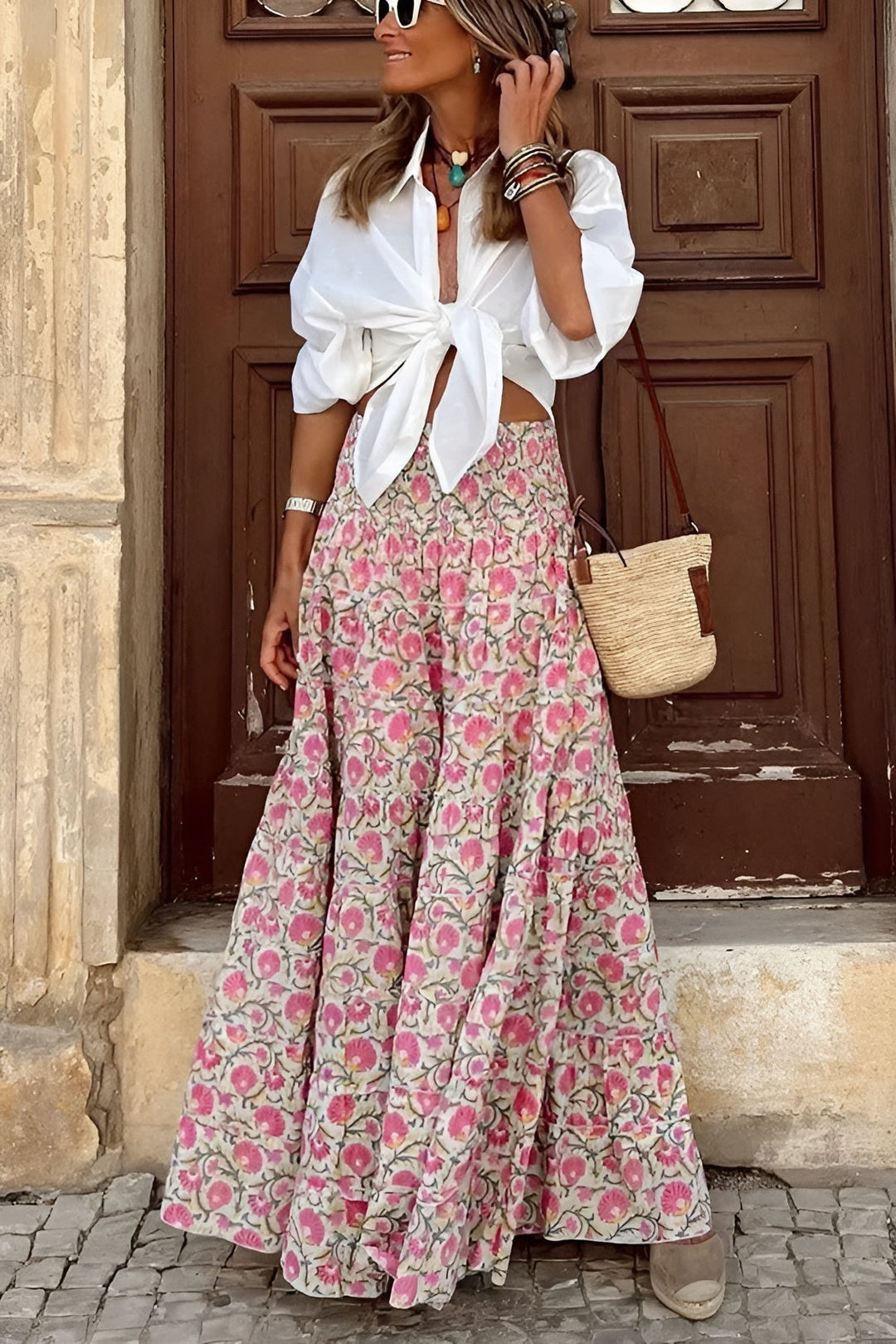 Bohemian long floral maxi skirt for women, featuring a smocked high waist and flowing tiered style.