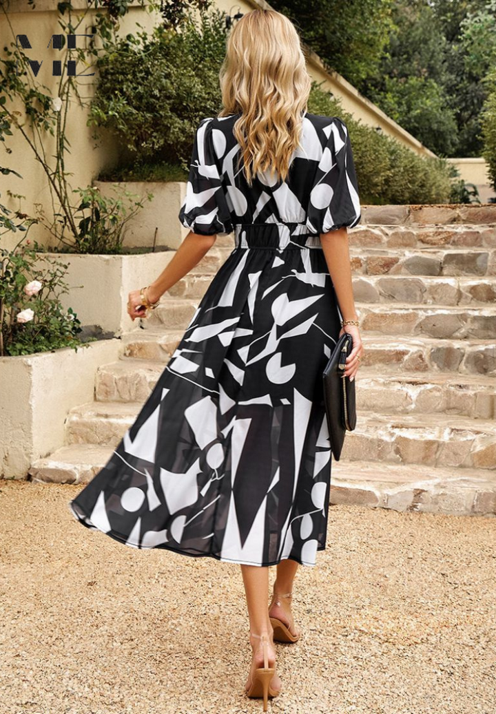 Tie waist detail on a women's V-neck floral print midi dress, offering an adjustable fit.
