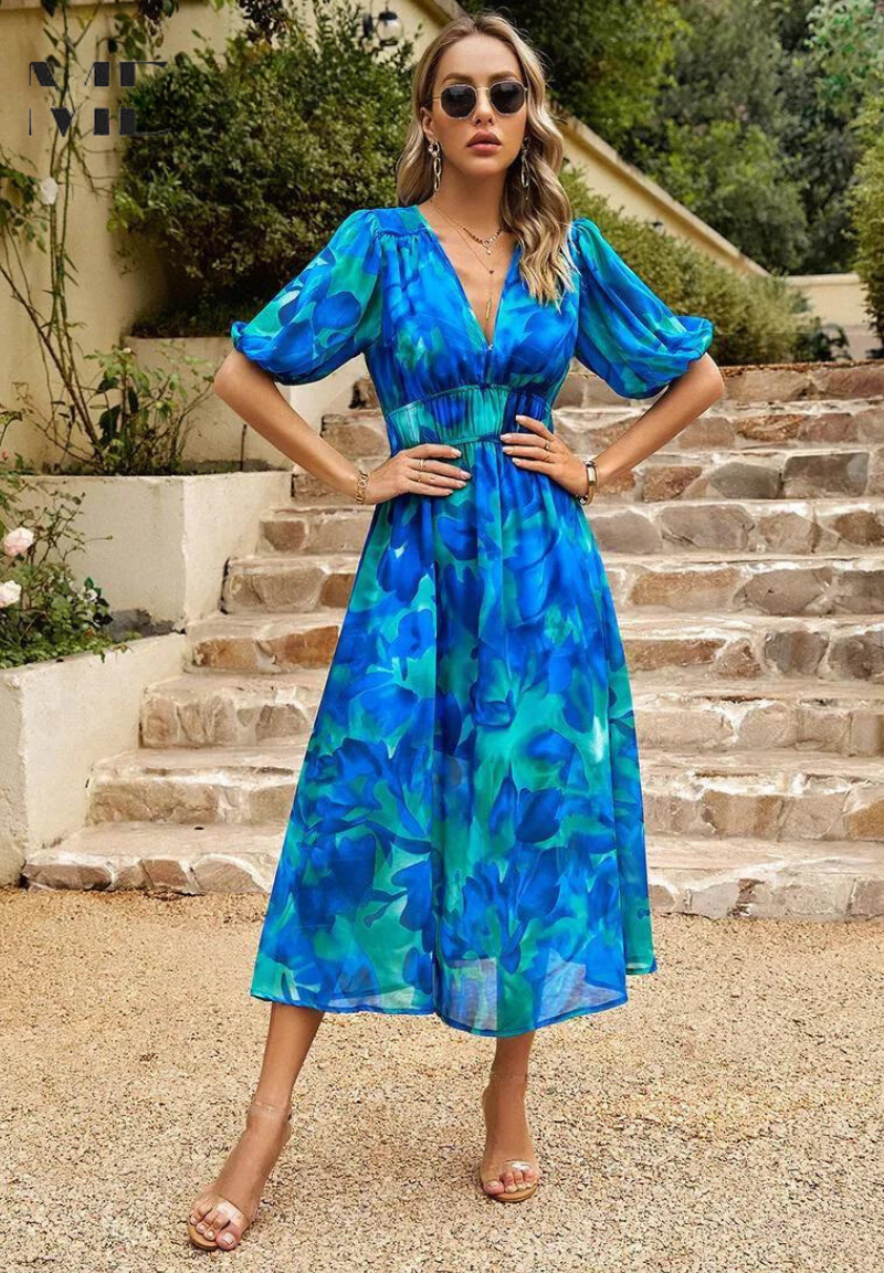 Women's floral print midi dress in a bright outdoor setting, perfect for spring fashion.