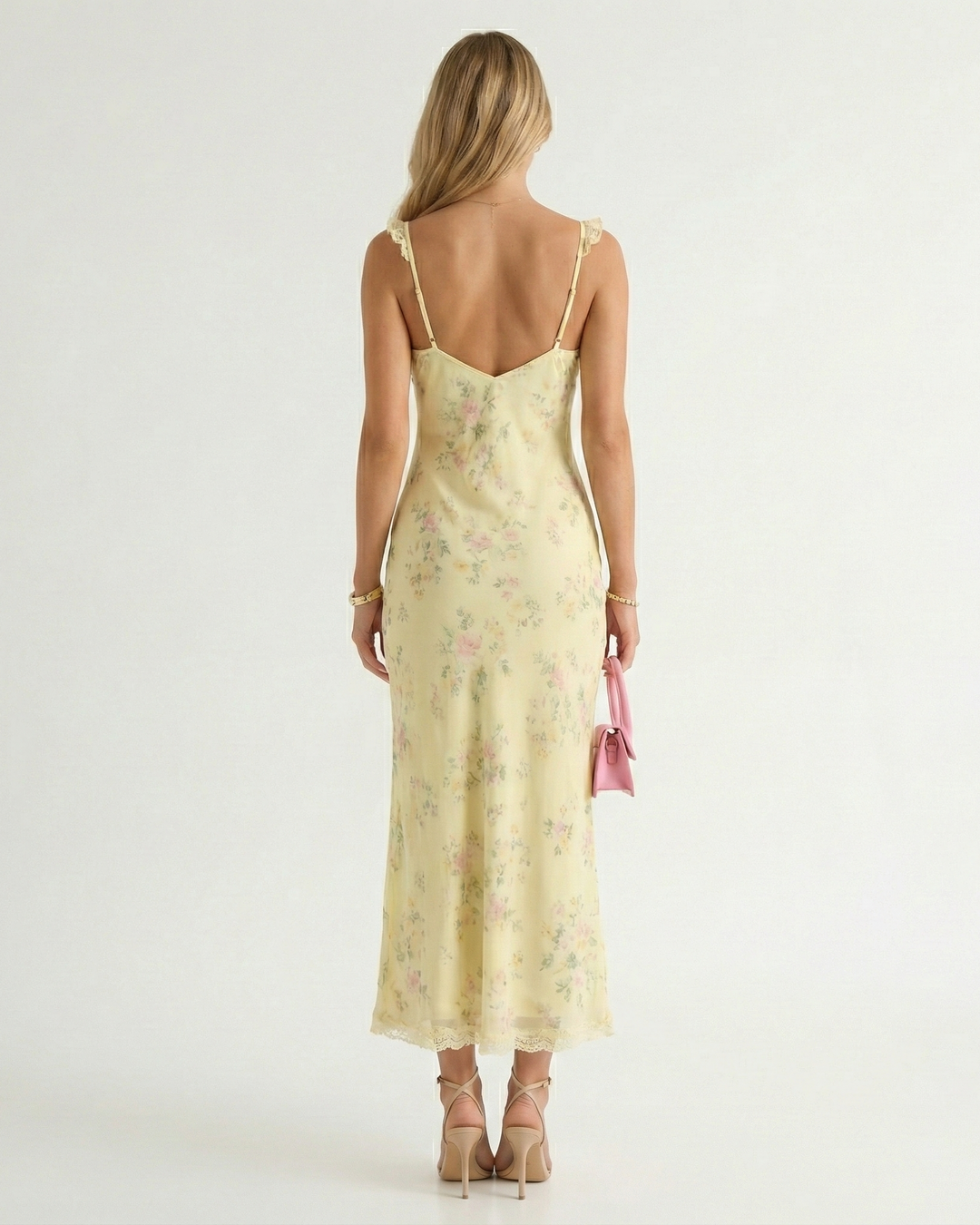Elegant backless midi dress for women featuring a vibrant floral pattern and thin spaghetti straps, ideal for resort wear.