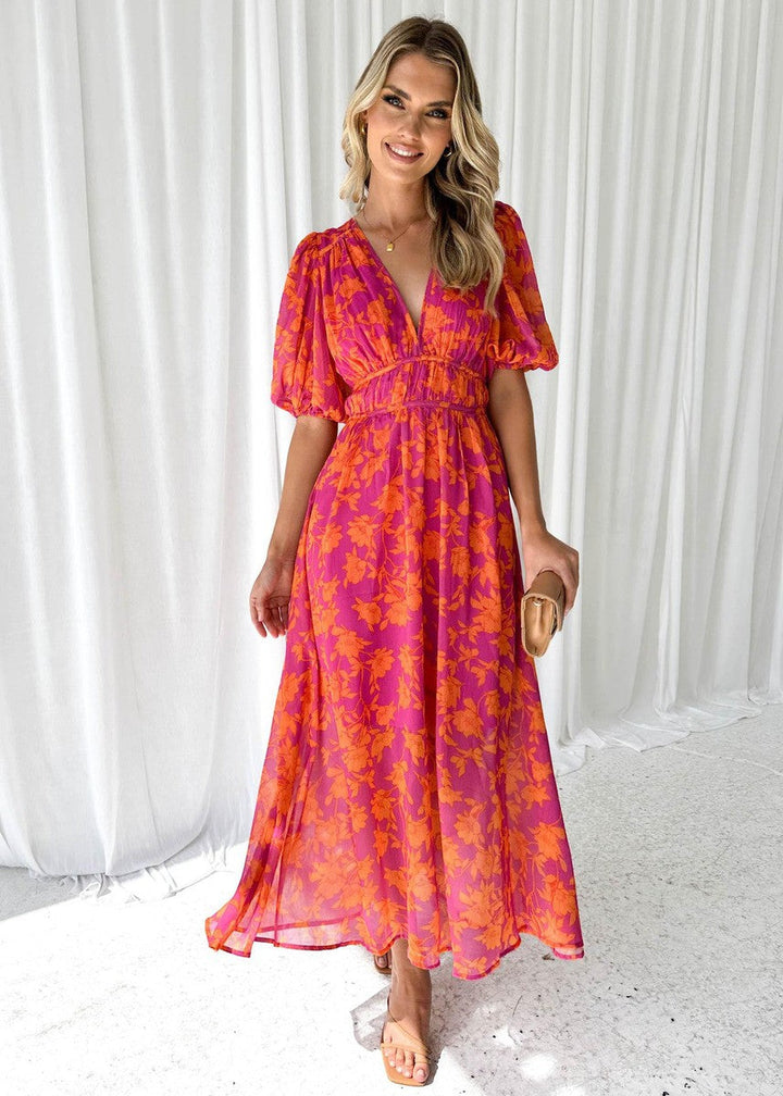 Stylish women's floral midi dress featuring puff sleeves and V-neck, a beautiful outfit for wedding guests.