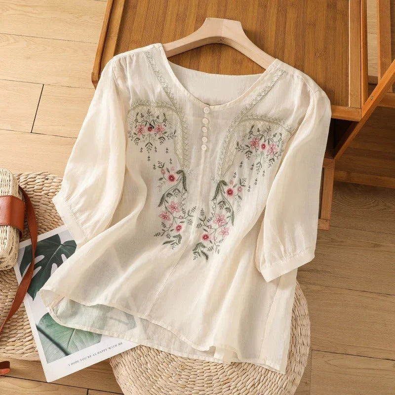 Women's embroidered floral blouse, relaxed fit with V-neck & 3/4 sleeves. Chic summer comfort top.