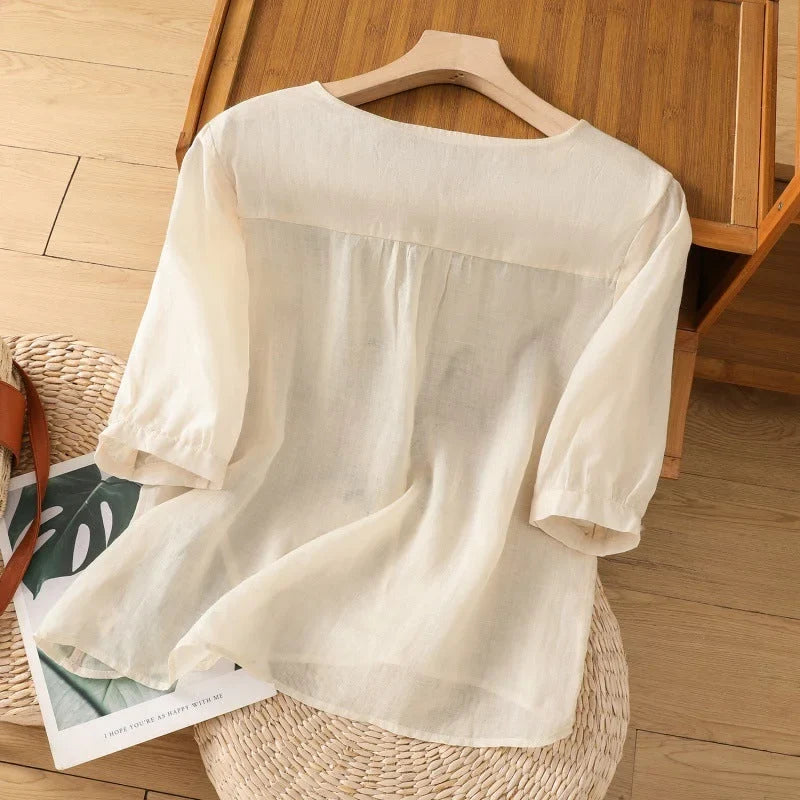 Lightweight women's floral V-neck blouse, 3/4 sleeves. Relaxed summer top for elegant casual style.