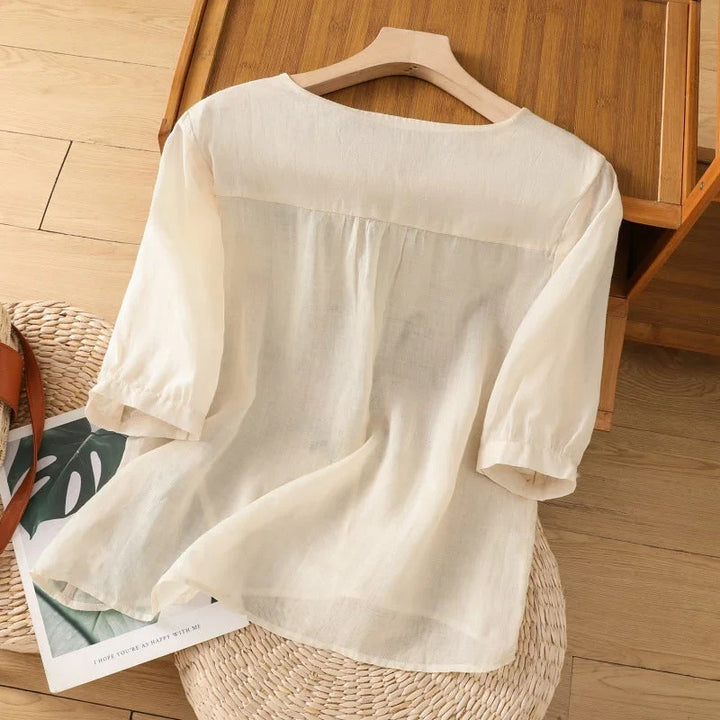 Lightweight women's floral V-neck blouse, 3/4 sleeves. Relaxed summer top for elegant casual style.