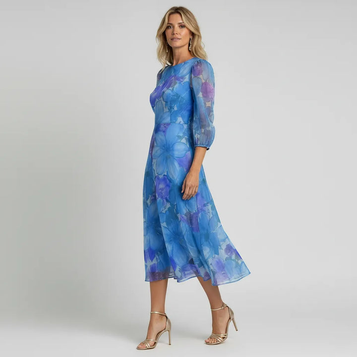 Stylish spring/summer midi dress for women, showcasing floral print and sheer puff sleeves.