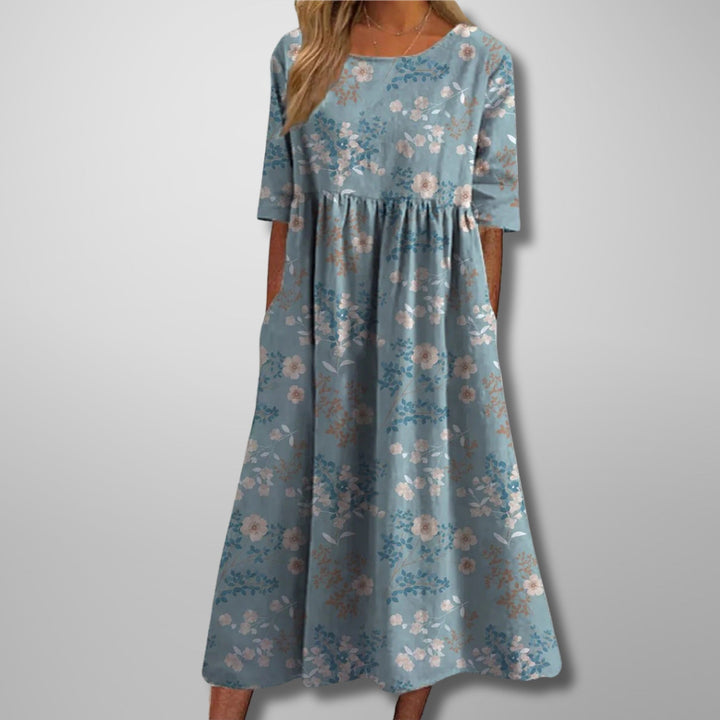 Stylish women's floral summer maxi dress with a square neckline, 3/4 sleeves, and functional pockets.