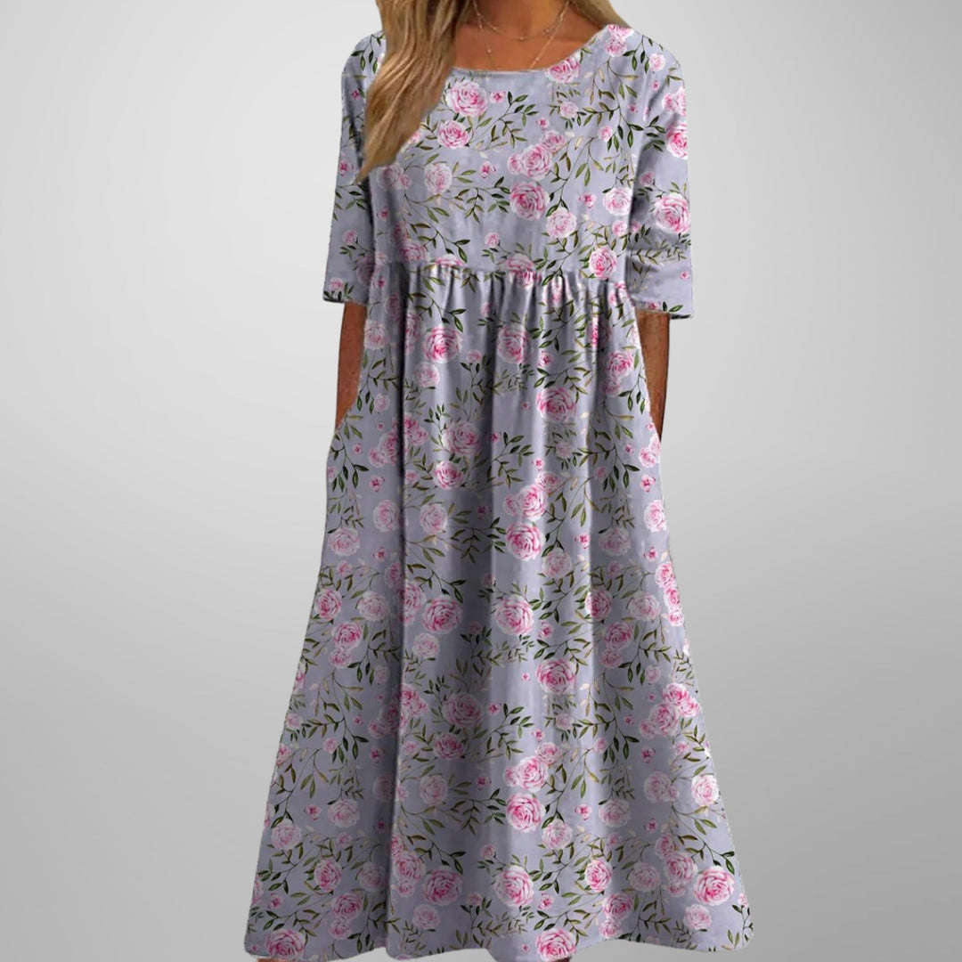 Vacation-ready women's floral maxi dress, featuring a flowy silhouette, empire waist, and hidden pockets.