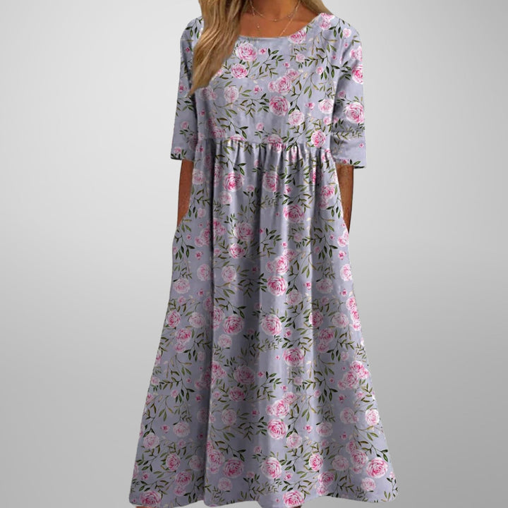 Vacation-ready women's floral maxi dress, featuring a flowy silhouette, empire waist, and hidden pockets.