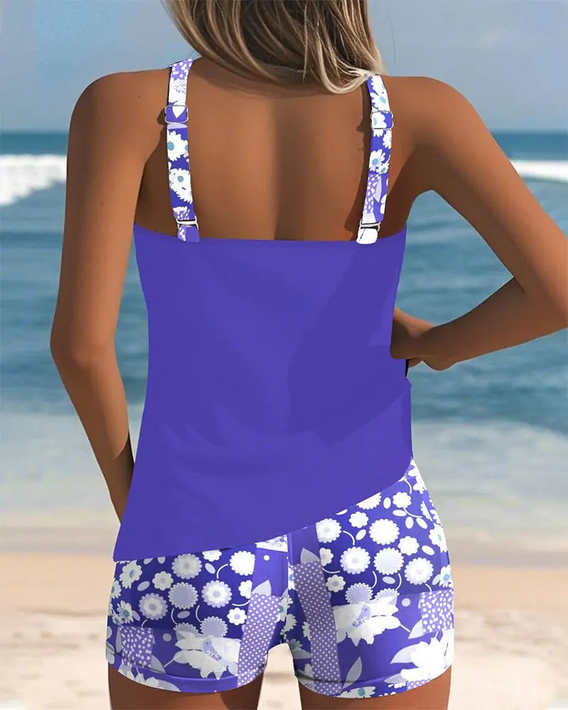 Vibrant floral women's tankini swimsuit with comfortable shorts coverage, great for vacation.