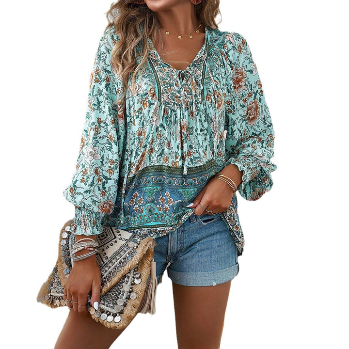 Chic women's floral blouse with long sleeves and adjustable tie front, perfect for spring.