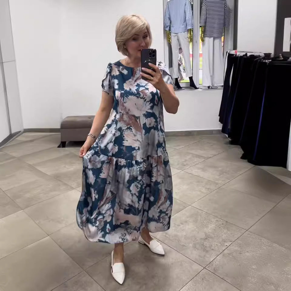 Women's floral tiered maxi dress for summer. Elegant, flowy, and comfortable vacation wear with a vibrant print.