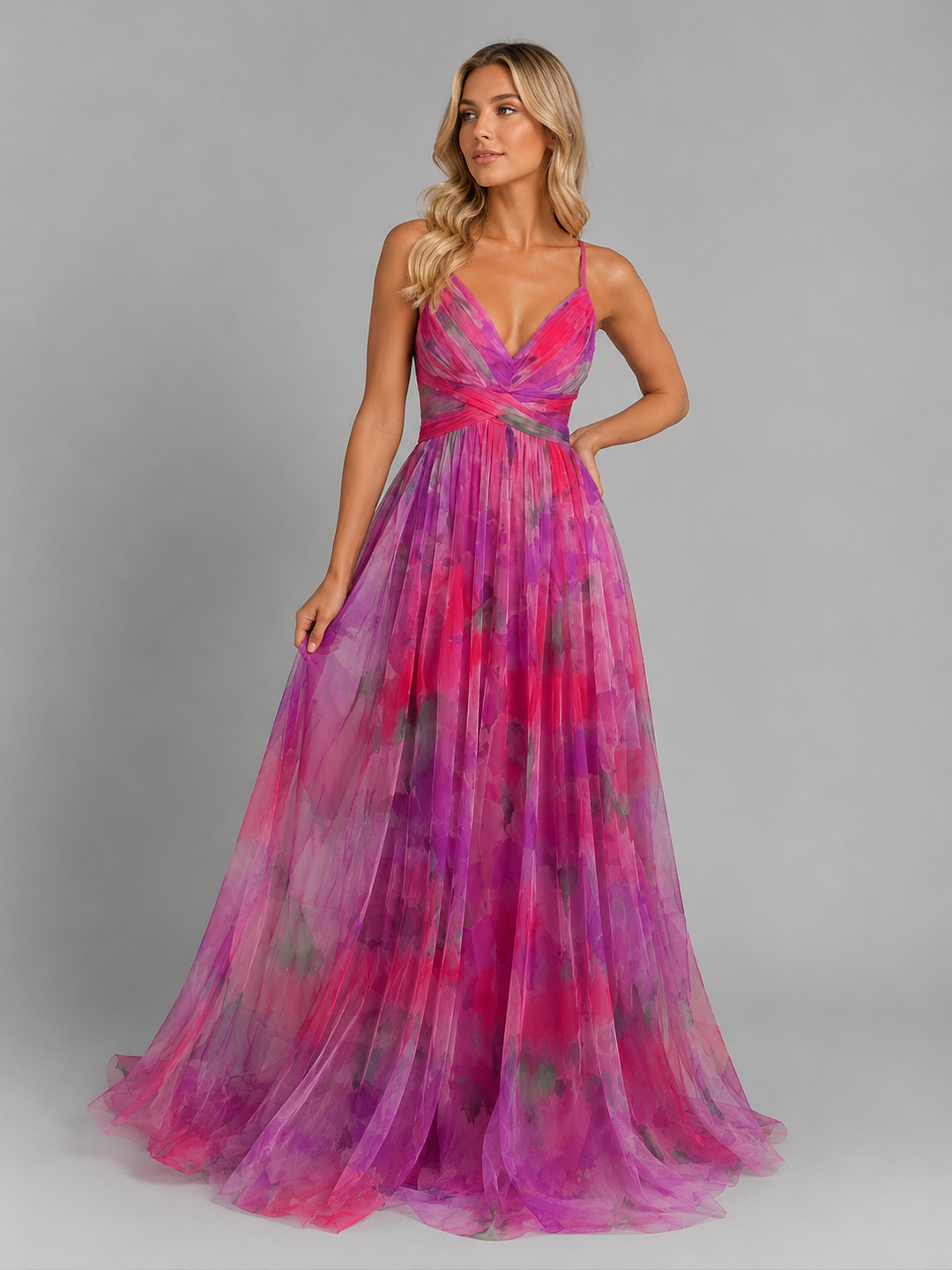 Woman in a vibrant floral V-neck maxi dress, enjoying a sunny day, perfect for beach or vacation.