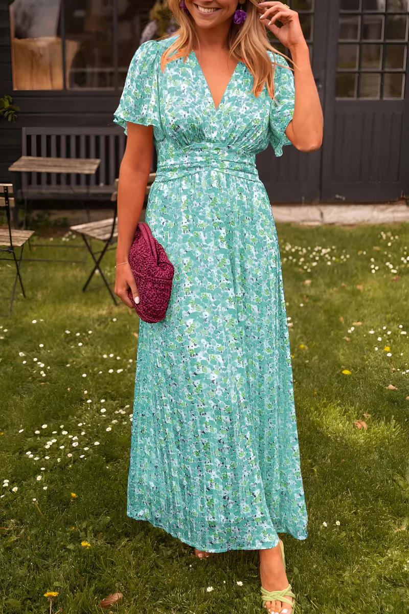 Woman wearing a stylish floral V-neck maxi dress, perfect for summer garden parties & elegant events.
