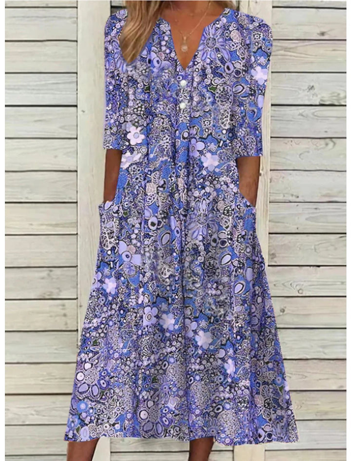 Flowy women's floral V-neck midi dress with 3/4 sleeves & pockets. Ideal comfortable summer vacation dress.
