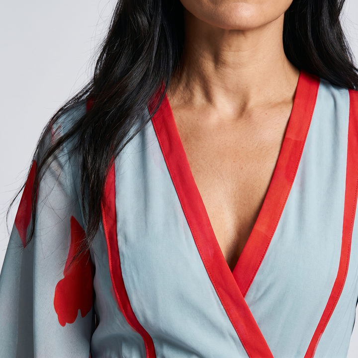 Comfortable women's floral maxi wrap dress featuring a bold red poppy print, long elegant design, and V-neck.