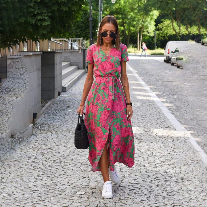 Vibrant floral print wrap midi dress for women, flowy & elegant. Short sleeves.