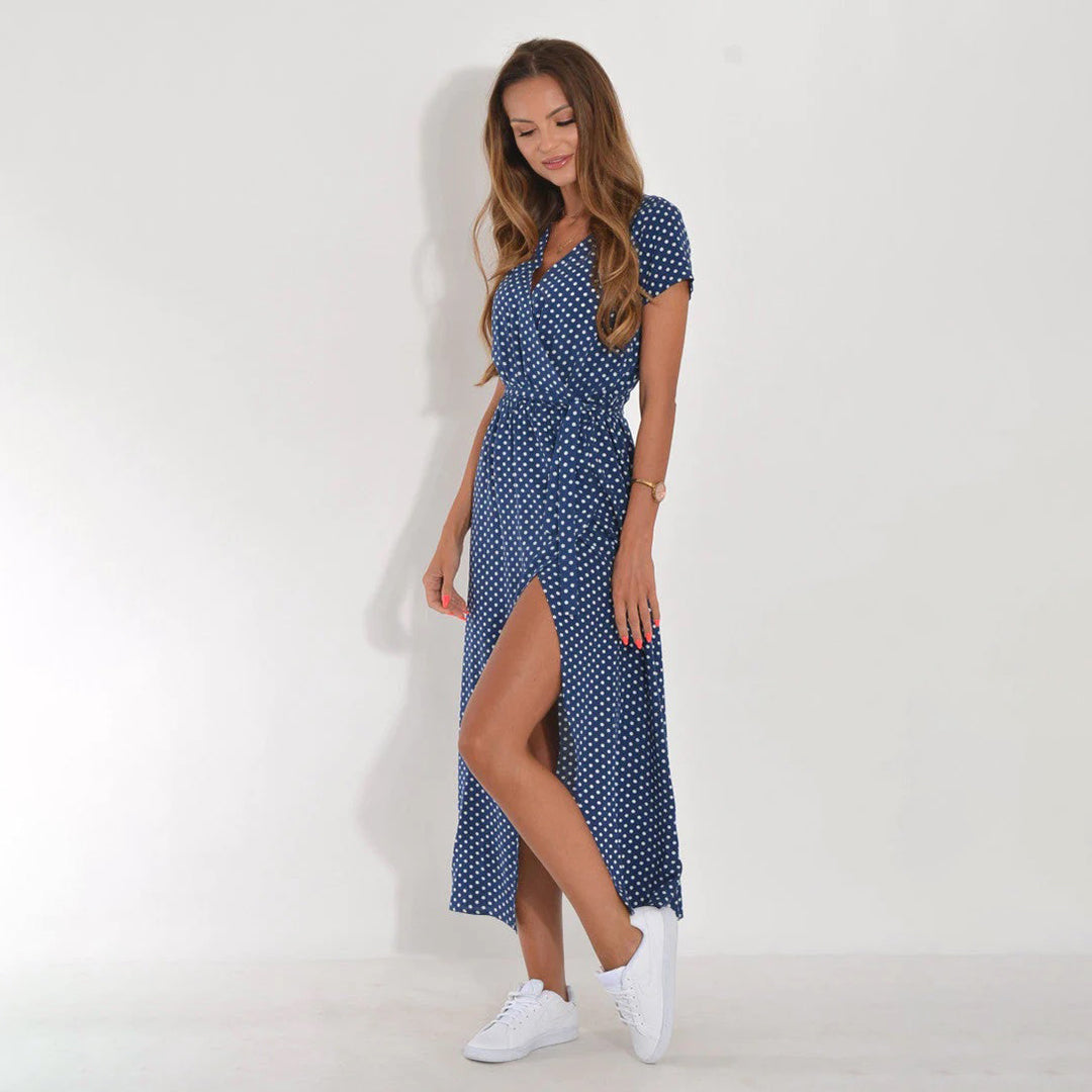 Women's elegant floral wrap midi dress, short sleeves, vibrant print, flowy fabric.