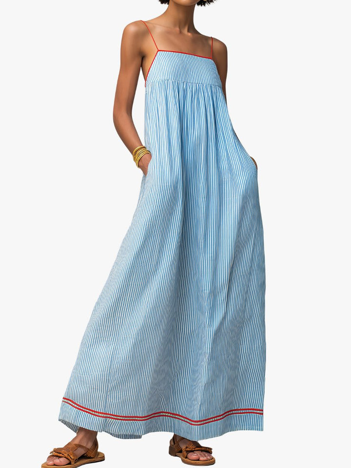Women's flowing striped maxi dress with practical pockets, perfect for summer casual wear.