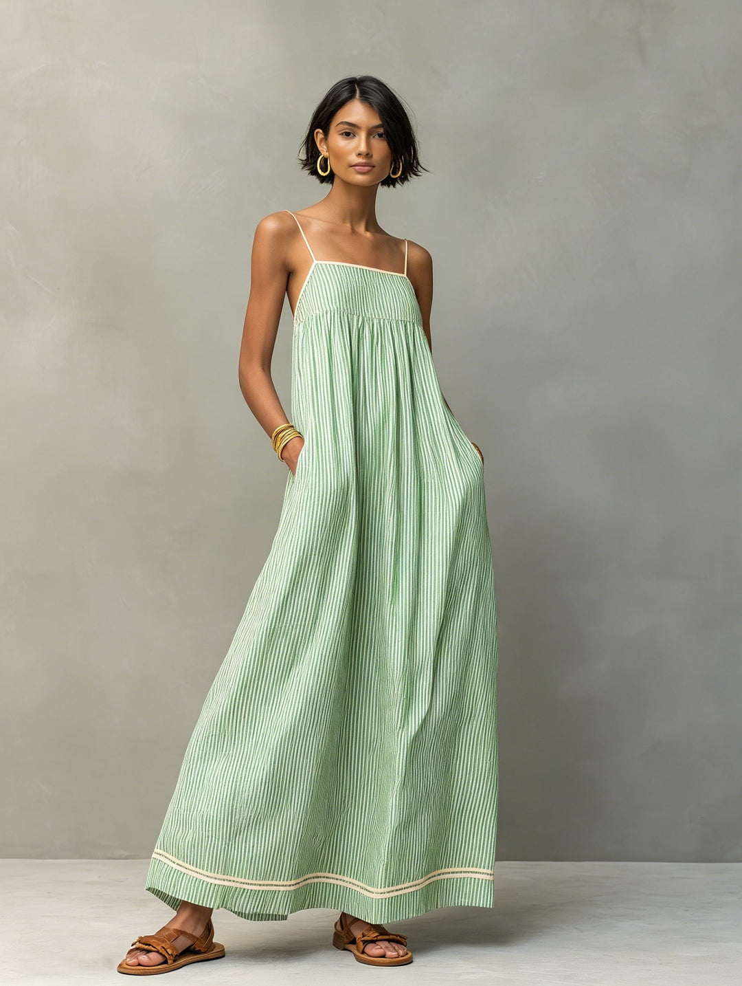 Stylish women's sleeveless striped maxi dress, great for beachwear & relaxed summer days.