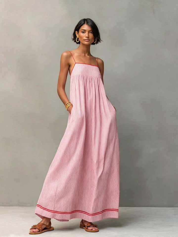 Comfortable women's flowy striped maxi dress with pockets, versatile for casual & vacation wear.