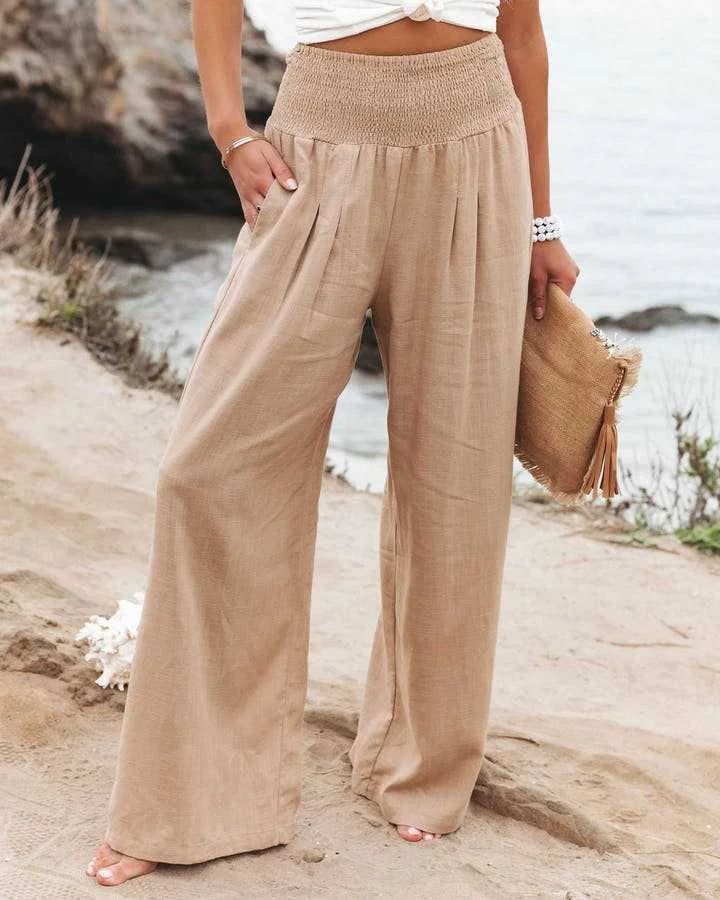Women's flowing wide leg pants with smocked high-waist, perfect for effortless casual and summer style.