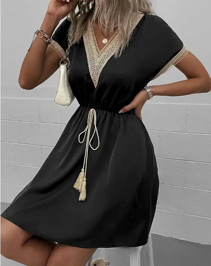 Black women's boho midi dress featuring a V-neck, tie waist, & short sleeves, ideal for versatile summer style.