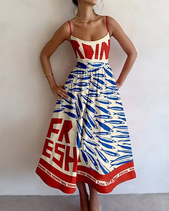 Women's flowy coastal art print midi dress. Elegant summer vacation outfit with striking design for women's fashion.