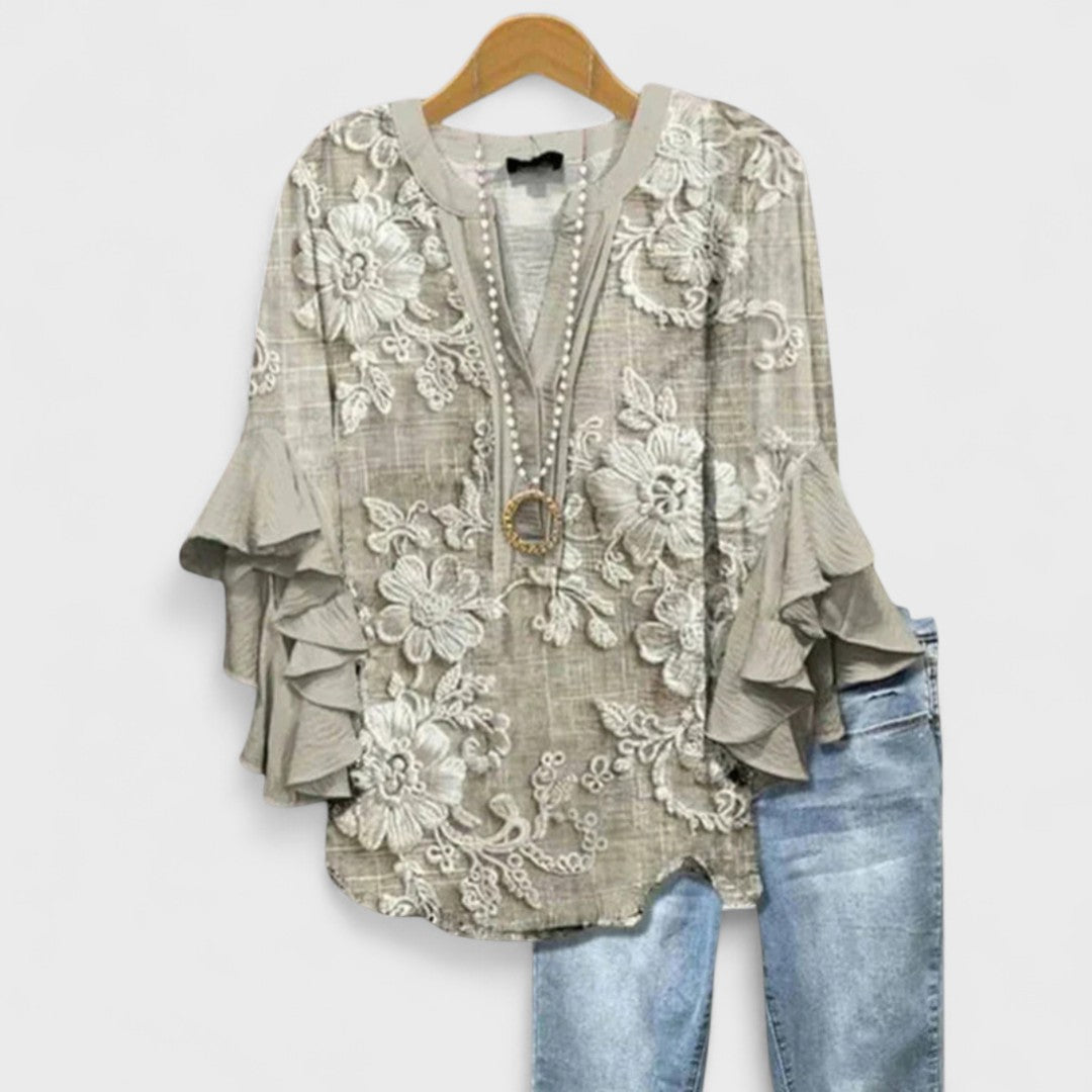 Bohemian women's floral ruffle top. Flowy blouse with v-neck and chic flare sleeves for summer style.