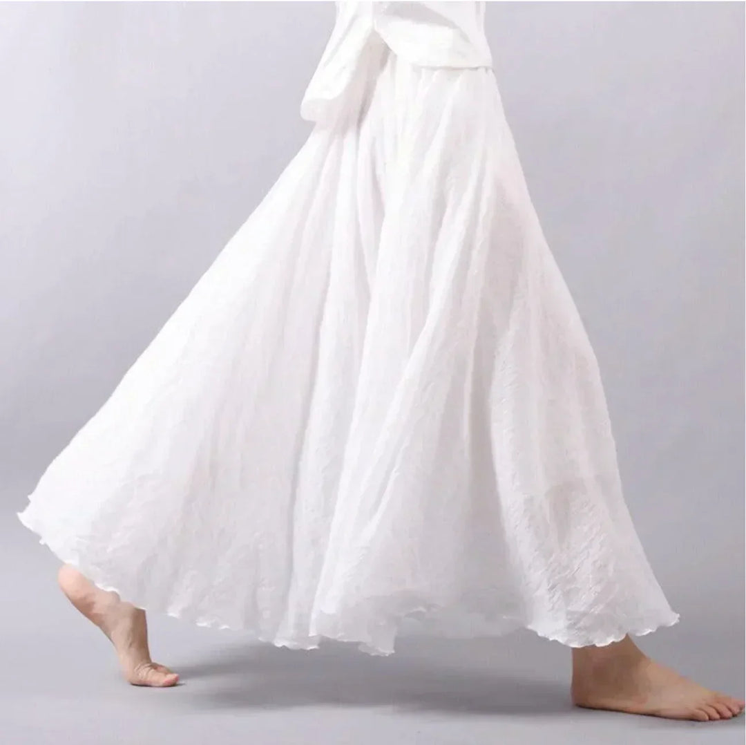 Model wearing a women's flowy high-waisted boho maxi skirt, showcasing its elegant drape and bohemian movement.