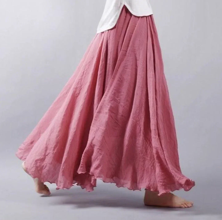 Women's versatile high-waisted boho maxi skirt, styled for a casual summer day or elegant beach outfit.